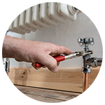 Person Using Wrench to Modify Plumbing